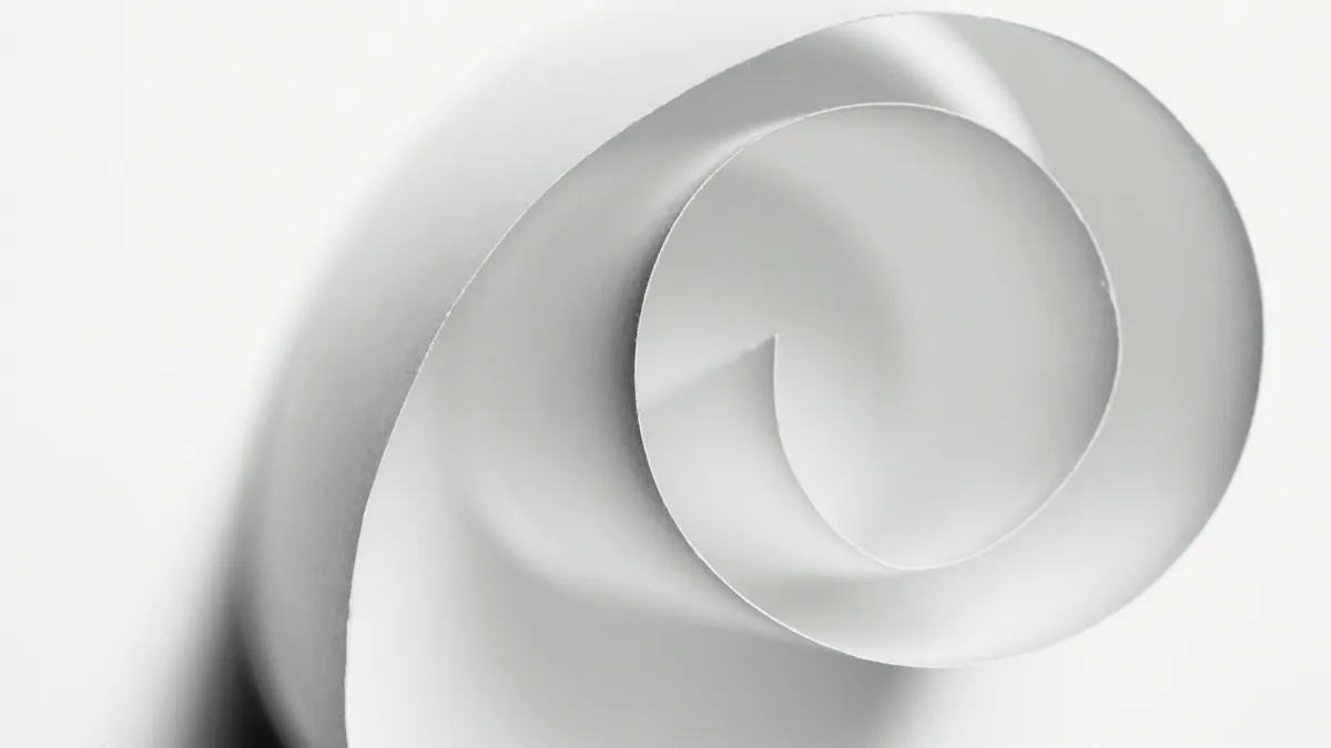 A continuous white paper spiral casts a soft shadow